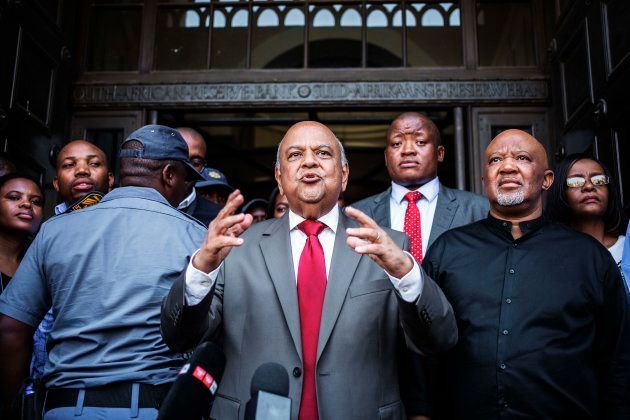 Former South African finance minister Pravin Gordhan (C) and his deputy Mcebisi Jonas were the first to go.