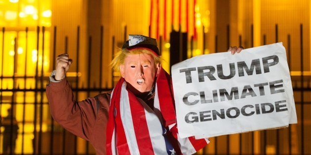 A protestor dressed as US President Elect Donald Trump takes part in a demonstration outside the US Embassy, in London, against Trump's stance on climate change.