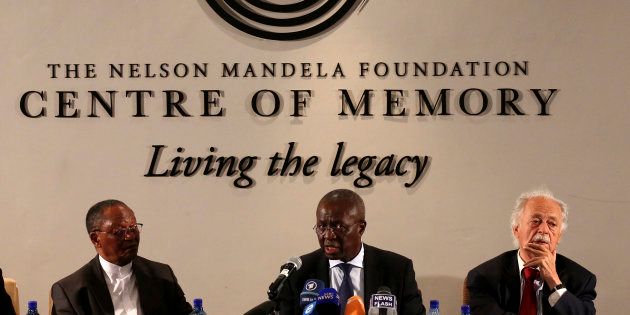 Deputy chief justice Dikgang Moseneke (C) reads Nelson Mandela's will flanked by professor Njabulo Ndebele (L) and advocate George Bizos on February 3 2014.
