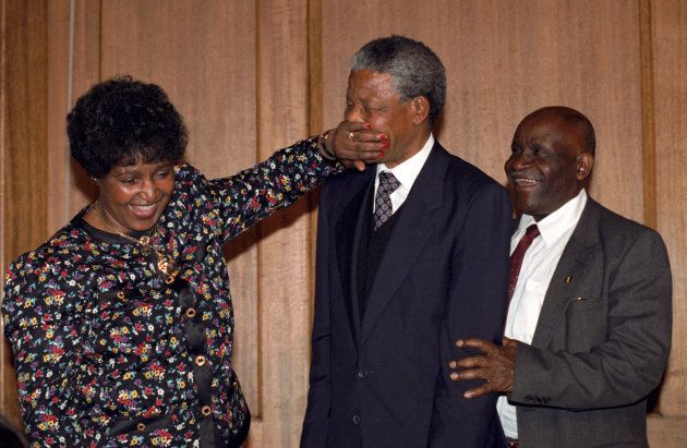 Nelson Mandela is playfully silenced by his wife, Winnie, as they leave their closing press conference in Whitehall.
