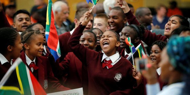 School children sing as they welcome South Africa's 2016 Rio Olympics medallists during their arrival at the O.R Tambo International Airport in Johannesburg, South Africa August 23, 2016.