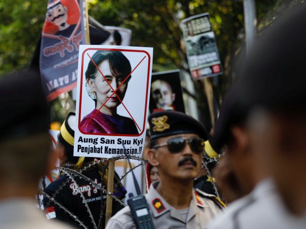 A placard with the picture of Aung San Suu Kyi, accusing her of crimes against humanity, is seen at a rally near the Myanmar embassy during a protest against the treatment of the Rohingya Muslims minority by the Myanmar government, in Jakarta, Indonesia September 8, 2017.