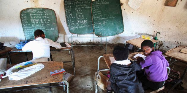 Children write notes from a makeshift black board at a school in Mwezeni village in South Africa's Eastern Cape Province in this picture taken June 5, 2012.