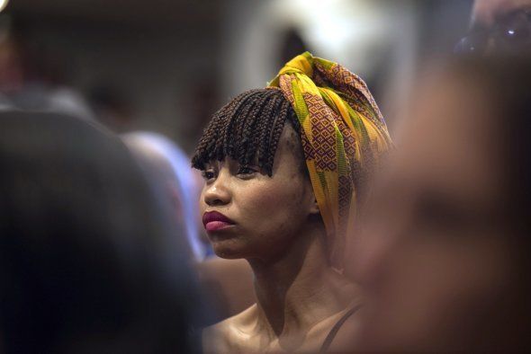 A woman listens to Ramaphosa's speech at the Nelson Mandela Foundation in Johannesburg on 05 December 2016. (Photo by Ihsaan Haffejee/Anadolu Agency/Getty Images)