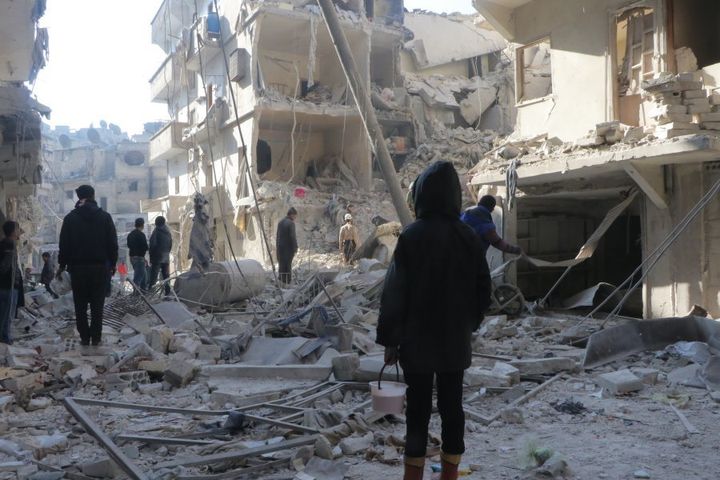 Search and rescue team members work at site after warcrafts belonging to Syrian army carried out airstrikes on the opposition controlled areas in Aleppo's Sukkeri region, Syria on December 4, 2016