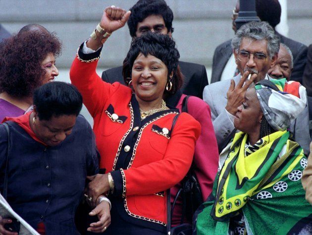 Winnie Mandela (C) dances outside Parliament after the approval of South Africa's new constitution, May 8, 1996.