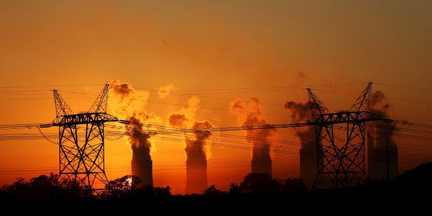 Electricity pylons are seen in front of the cooling towers at the Lethabo Thermal Power Station, an Eskom coal-burning power station near Sasolburg.