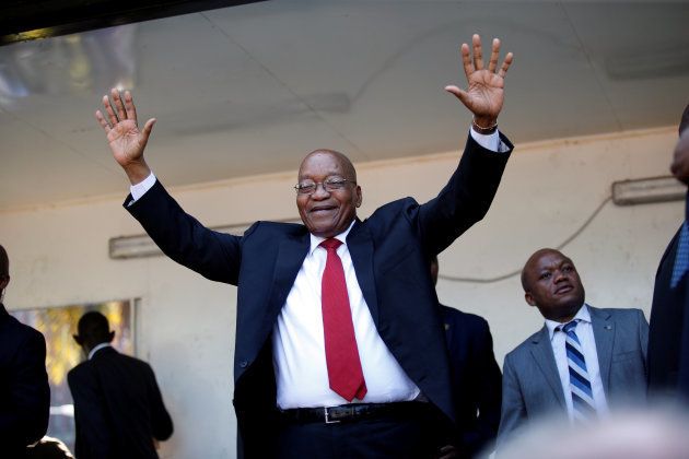 Jacob Zuma waves to his supporters on his way to the high court in Durban.