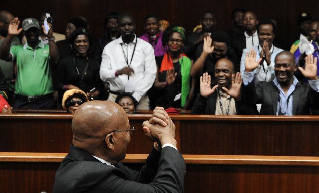 Jacob Zuma gestures to his supporters as he appears at the KwaZulu-Natal High Court in Durban.