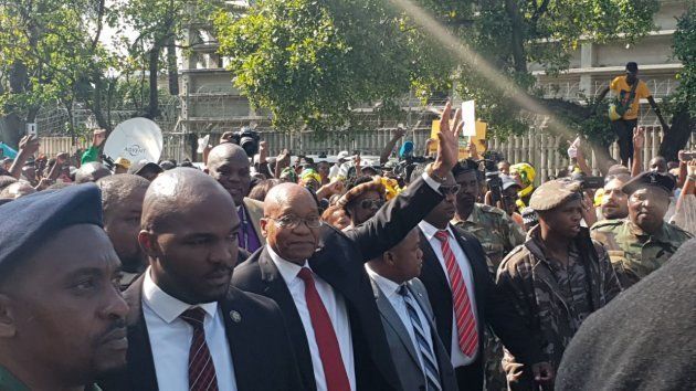 Jacob Zuma greets his supporters as he emerges from the Durban High Court.