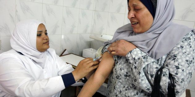 A nurse vaccinates a would-be pilgrim against encephalitis and H1N1 in a health centre in Cairo, November 8, 2009, ahead of the annual pilgrimage to Mecca.