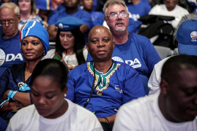 Johannesburg mayor and DA leader Herman Mashaba (C) sits in the crowd during policy resolutions at the federal congress in Pretoria on April 8, 2018. / AFP PHOTO / GULSHAN KHAN (Photo credit should read GULSHAN KHAN/AFP/Getty Images)