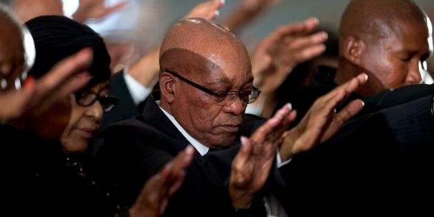 Winnie Madikizela-Mandela, Nelson Mandela's former wife, left, South African President Jacob Zuma, center, and grandson Mandla Mandela, right, pray during a memorial service for Mandela at the Bryanston Methodist Church in Bryanston suburb of Johannesburg, South Africa, Sunday Dec. 8, 2013.