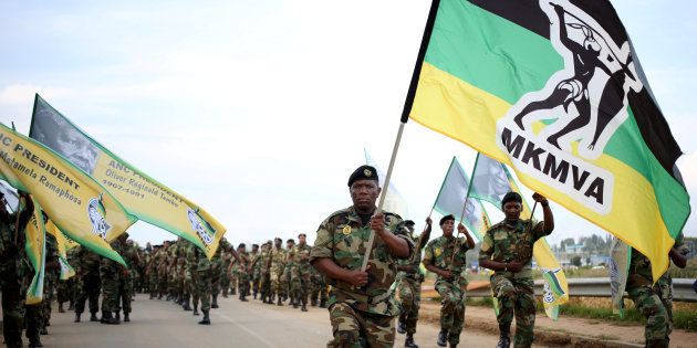 Members of the Umkhonto We Sizwe Military Veterans Association (MKMVA) hold flags as they arrive at the home of the late Winnie Mandela in Soweto, South Africa, April 4, 2018.