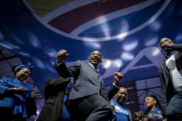 South African opposition party, the Democratic Alliance (DA) leader Mmusi Maimane (C), dances with other constituent leaders during the party congress in Pretoria on April 7, 2018. / AFP PHOTO / GULSHAN KHAN (Photo credit should read GULSHAN KHAN/AFP/Getty Images)