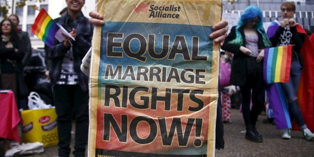 A gay-rights activist holds a banner during a rally supporting same-sex marriage in Sydney, Australia.