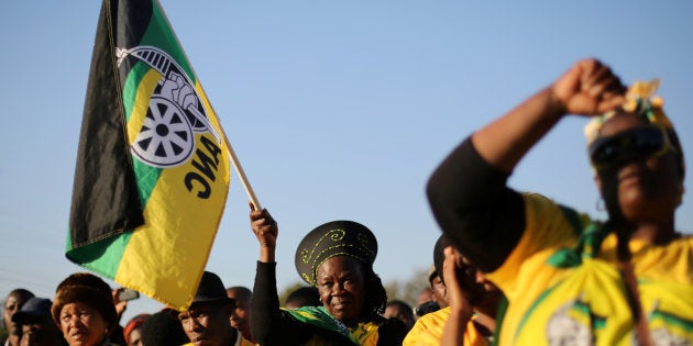 Supporters of the African National Congress hold the party flag during ANC president Jacob Zuma's election campaign.