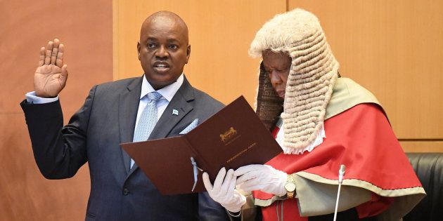 Botswana's new president, Mokgweetsi Masisi (L), takes the oath as the fifth president of Botswana in Gaborone on April 1, 2018, administered by chief Justice Maruping Dibotelo.