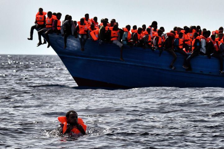 Migrants wait to be rescued as they drift in the Mediterranean Sea some 20 nautical miles north off the coast of Libya on October 3, 2016. Italy coordinated the rescue of more than 5,600 migrants off Libya, three years to the day after 366 people died in a sinking that first alerted the world to the Mediterranean migrant crisis.