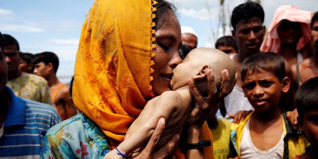 ATTENTION EDITORS - VISUAL COVERAGE OF SCENES OF INJURY OR DEATH Hamida, a Rohingya refugee woman mourns as she holds her 40-day-old son, who died after a boat capsized in the shore of Shah Porir Dwip, in Teknaf, Bangladesh September 14, 2017. REUTERS/Mohammad Ponir Hossain TEMPLATE OUT TPX IMAGES OF THE DAY