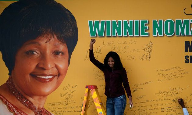 A women gestures after writing on a tribute wall with the portrait of the late Winnie Mandela, after its unveiling outside Luthuli house, the ANC headquarters in Johannesburg, South Africa April 9, 2018.