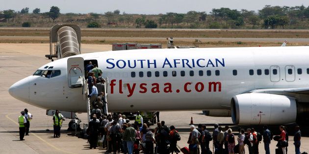 Passengers board a South African Airways Boeing 737 aircraft at the Kamuzu International Airport in Lilongwe on October 25 2009.