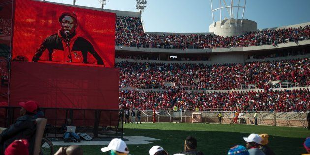 Economic Freedom Fighters (EFF) party supporters look on during a speech by EFF President Julius Malema during the party's final rally ahead of municipal elections at the Peter Mokaba Stadium in Polokwane on July 31, 2016. The latest Ipsos opinion polls suggest that the ANC, which has ruled since the end of apartheid in 1994, could be under threat in three more major cities -- Pretoria, Johannesburg and Port Elizabeth -- at the election. The radical leftist Economic Freedom Fighters (EFF) party is also seeking to make a major impact in its first municipal elections.