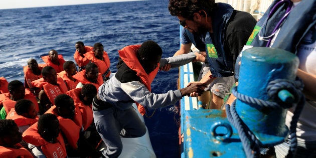 A migrant is transferred from a dinghy by members of the German NGO Jugend Rettet during a rescue operation, off the Libyan coast in the Mediterranean Sea September 21, 2016. REUTERS/Zohra Bensemra