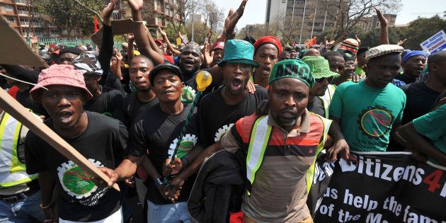 Miners from Marikana, their families and supporters march to the Union Buildings in Pretoria, to protest against the government's lack of funding for the Marikana commission of inquiry September 12, 2013.