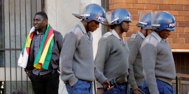 A Zimbabwean anti-riot police stand guard outside the Harare Magistrates court before the arrival of arrested Pastor Evan Mawarire, in the capital Harare, Zimbabwe, July 13, 2016.