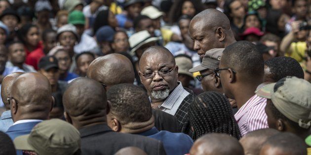 Secretary General of the African National Congress ruling party (ANC) Gwede Mantashe (C) looks back among the crowd outside the Luthuli House, the ANC headquarters.