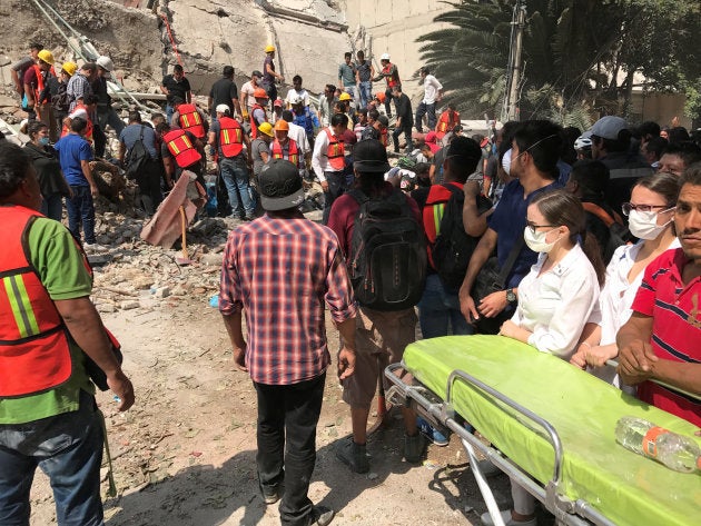 Paramedics get ready as people search the site of a collapsed building after an earthquake hit in Mexico City, Mexico September 19, 2017. REUTERS/Claudia Daut