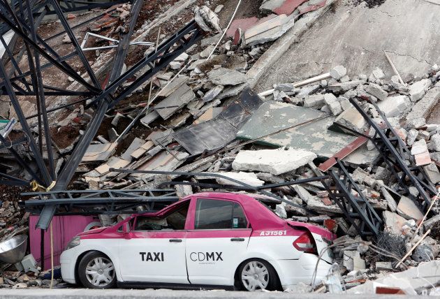A damaged taxi is seen next to a collapsed building after an earthquake in Mexico City, Mexico September 19, 2017. REUTERS/Ginnette Riquelme