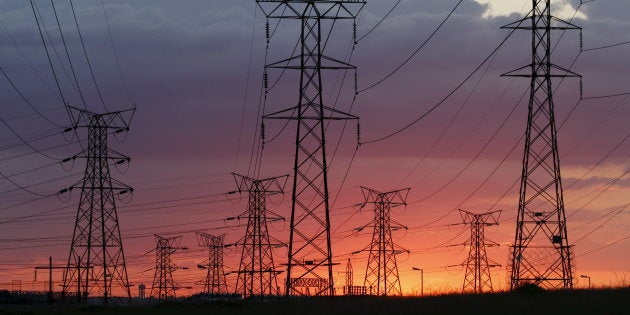 Electricity pylons are seen as the sun sets in Soweto, outside Johannesburg, April 17, 2016.