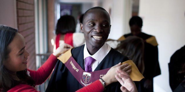 Joseph Munyambanza, a student from the Democratic Republic of Congo gets dressed before the African Leadership Academy (ALA) graduation day ceremony in the school in Honeydew, west of Johannesburg, South Africa.