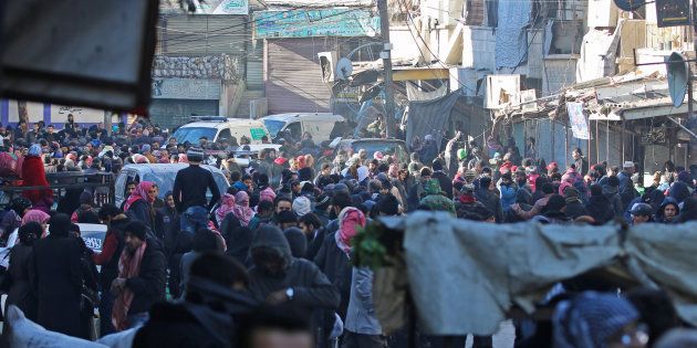 People gather to be evacuated from al-Sukkari rebel-held sector of eastern Aleppo, Syria December 15, 2016.