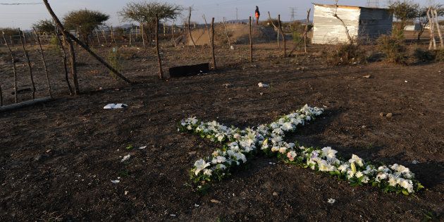 A remembrance cross made of flowers is seen during the commemoration of the 2012 Marikana massacre on August 16, 2016 in Rustenburg, South Africa. August 16, 2016 marks 4-years since 34 miners were killed during a wage increase protest at Lonmin mine. (Photo by Gallo Images / Beeld / Felix Dlangamandla)