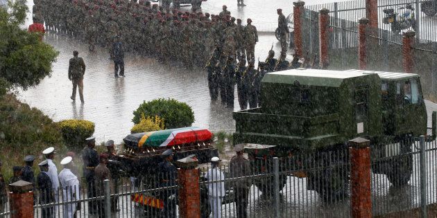 Winnie Madikizela-Mandela's coffin is taken from the Orlando stadium in the pouring rain during her funeral service in Soweto, South Africa April 14, 2018.