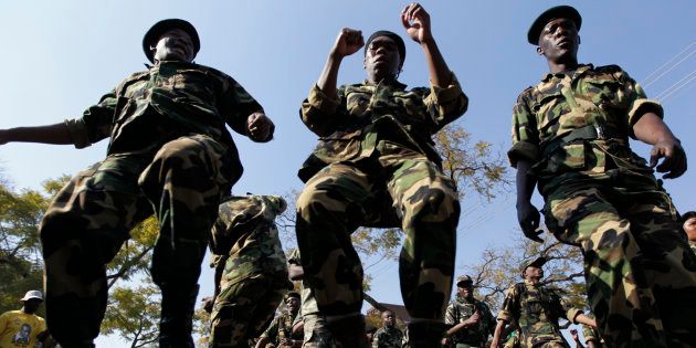 Members of the Umkhonto weSizwe Military Veterans' Association chant slogans and dance in support of ailing former South African President Nelson Mandela outside the Medi-Clinic Heart Hospital where he was being treated in Pretoria June 30, 2013.