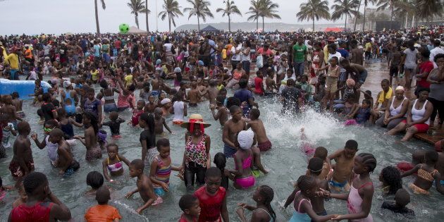 Beach goers celebrate New Year's Day in the paddling pools on the beachfront in Durban, South Africa, January 1, 2016.