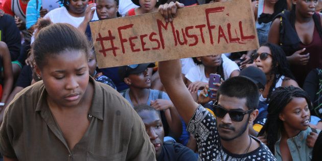 Students protest against a proposed hike in tuition fees outside the parliament precinct on 21 October 2015 in Cape Town.