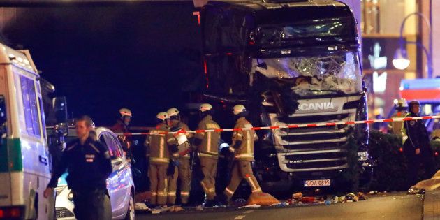 Police and emergency workers stand next to a crashed truck at the site of an accident at a Christmas market on Breitscheidplatz square near the fashionable Kurfuerstendamm avenue in the west of Berlin, Germany, December 19, 2016.