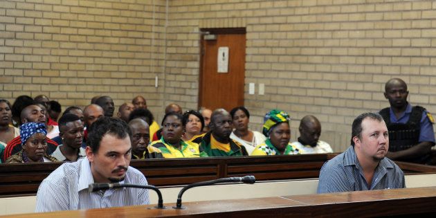 Theo Jackson and Willem Oosthuizen during their bail application hearing at the Middelburg Magistrates Court after they were arrested for allegedly assaulting and forcing Rethabile Victor Mlotshwa into a coffin on December 08, 2016 in Middelburg, South Africa. Jackson and Oosthuizen, who are accused of racism and assault were denied bail.