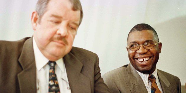Former safety and security minister Sydney Mufamadi (R) and former assistant commissioner Suiker Brits (L) release findings of a police investigation ordered by former president Nelson Mandela into farm killings that have swept the country.