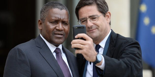 Africa's richest man Aliko Dangote (L) poses for a selfie picture with French General Director of the Banque Publique d'Investissement (BPI, Public Investment Bank) Nicolas Dufourcq as they leave the Elysee presidential Palace following a meeting between French President and French and African businessmen on October 7, 2016 in Paris.