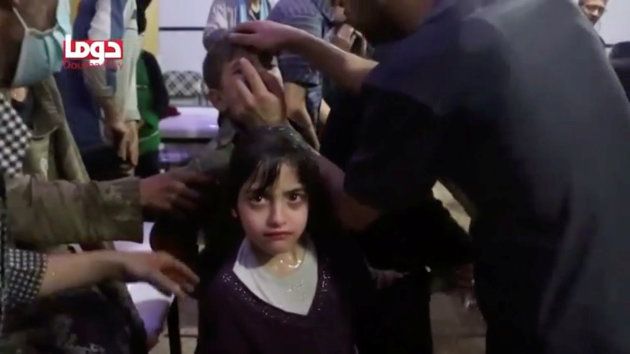A girl looks on following alleged chemical weapons attack, in what is said to be Douma, Syria in this still image from video obtained by Reuters on April 8, 2018.