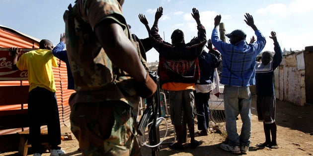 South African soldiers check the documents of residents of the Diepsloot township north of Johannesburg, South Africa, Friday July 9 2010. Police and the army have deployed because of growing rumors of possible rise in xenophobic violence after Sunday's World Cup Soccer's final.