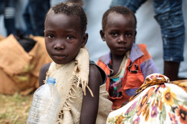 Young refugees from the Democratic Republic of Congo wait to board a bus from the Nsonga landing site to take them to a reception centre on April 9, 2018 in Nsonga, Uganda.