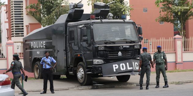 Policemen stand next to a water cannon truck in Abuja, Nigeria December 11, 2017.