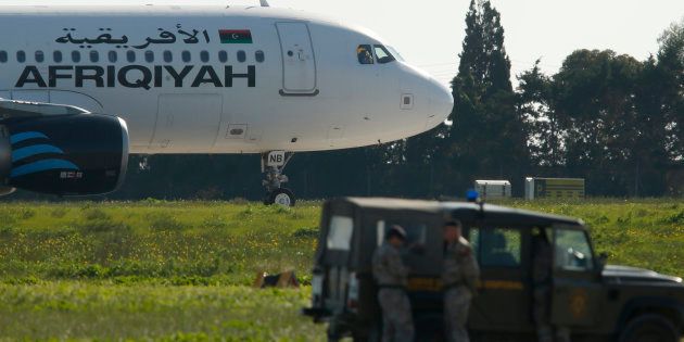 Maltese troops survey a hijacked Libyan Afriqiyah Airways Airbus A320 on the runway at Malta Airport, December 23, 2016.